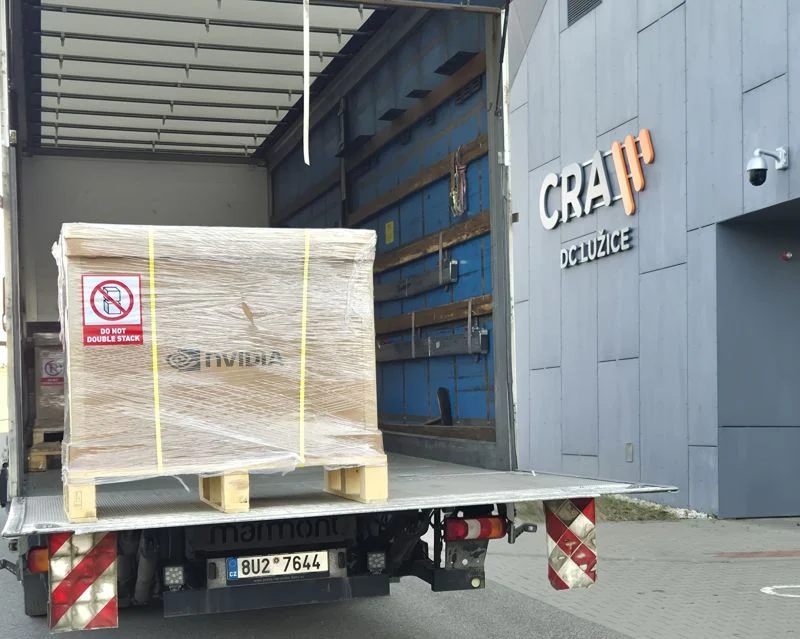 An NVIDIA crate holding a DGX B300 system on a truck tail lift at the datacenter entrance.
